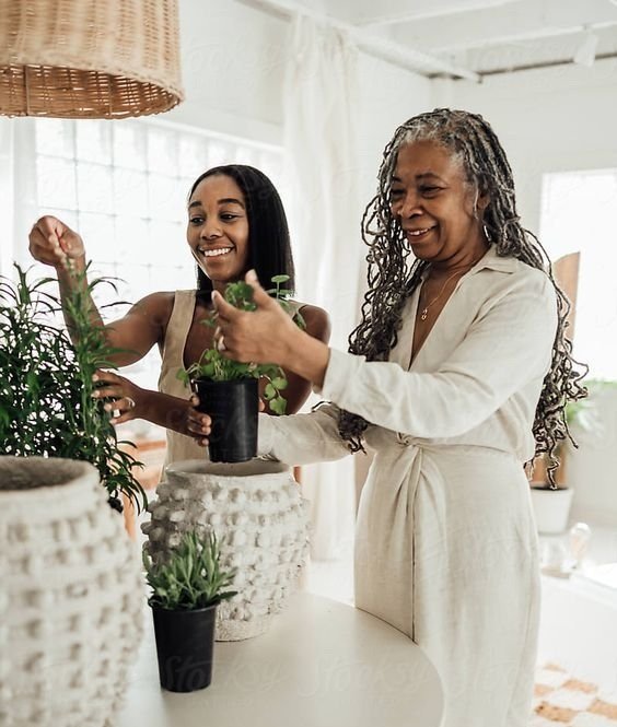 a woman and a woman holding a plant