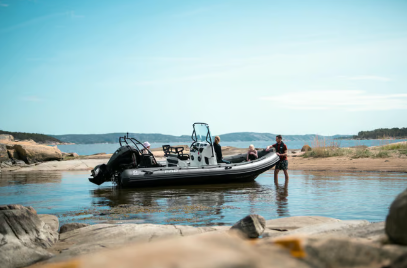 a group of people in a boat on a beach