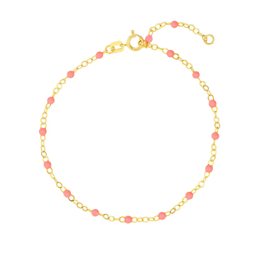 a gold chain with pink beads