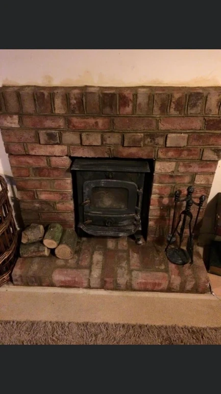 a fireplace with a brick hearth