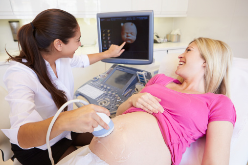 a woman on a bed with a ultrasound machine