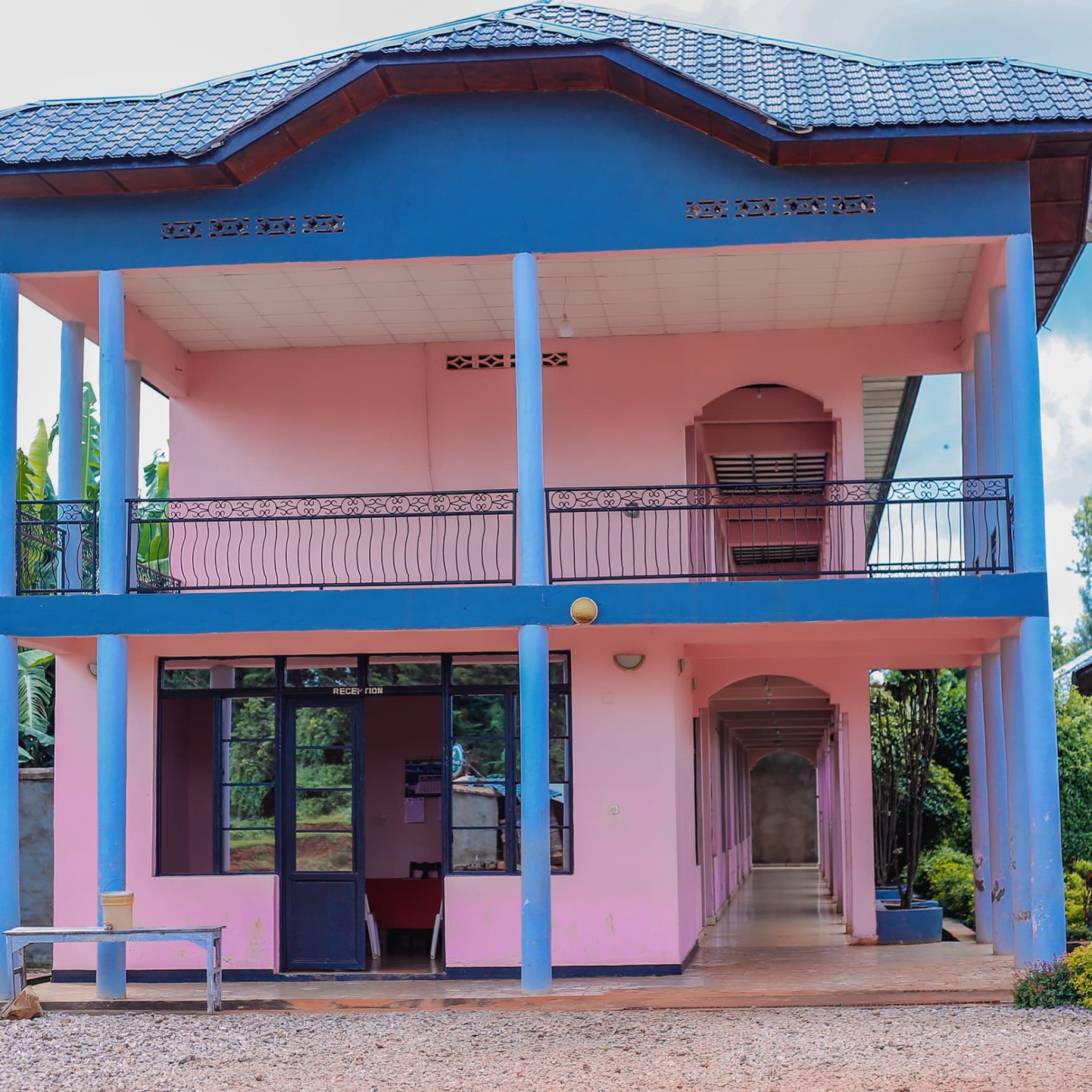 a pink and blue house with a porch