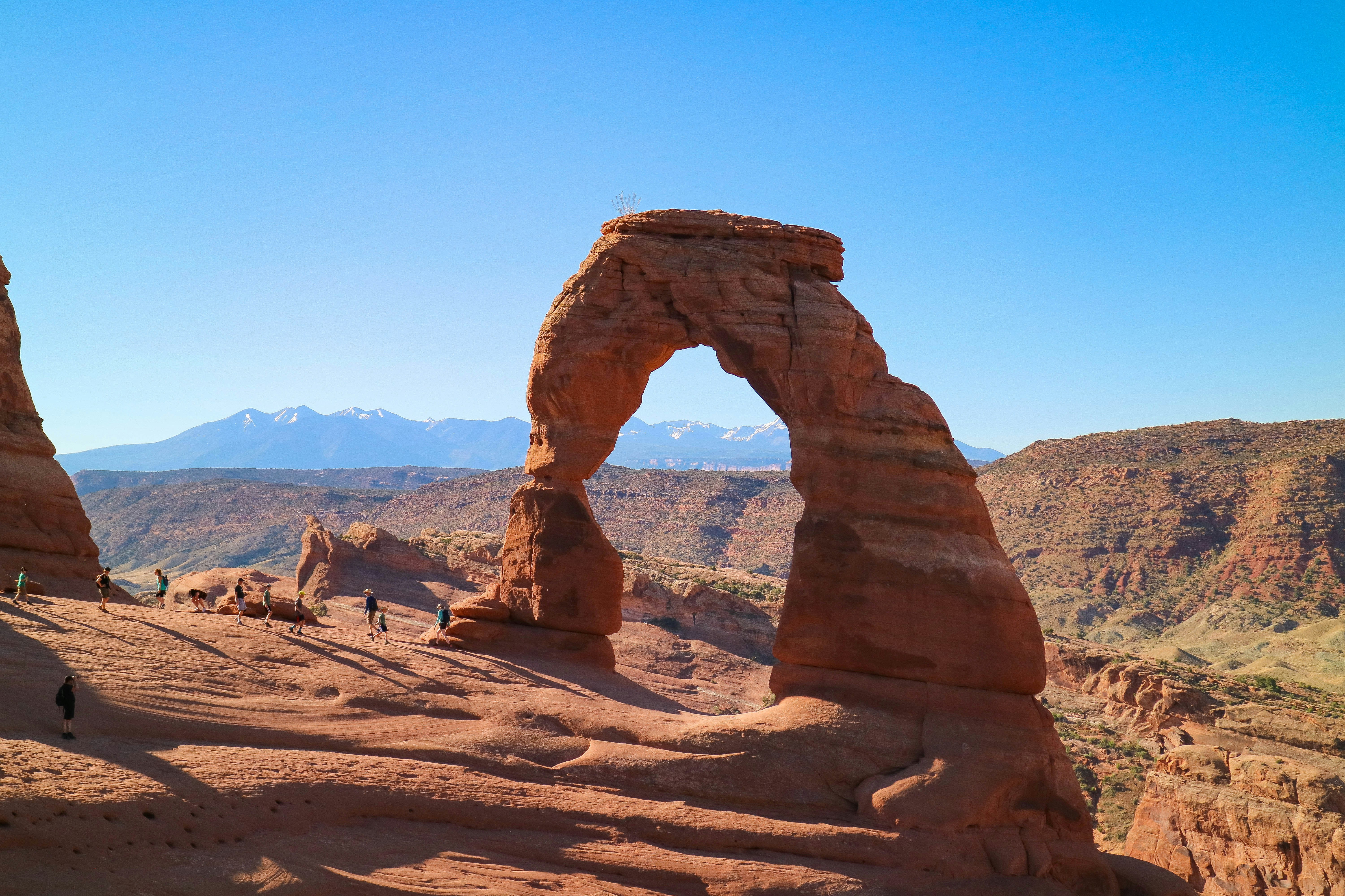 a rock formation in the desert with Arches National Park in the background