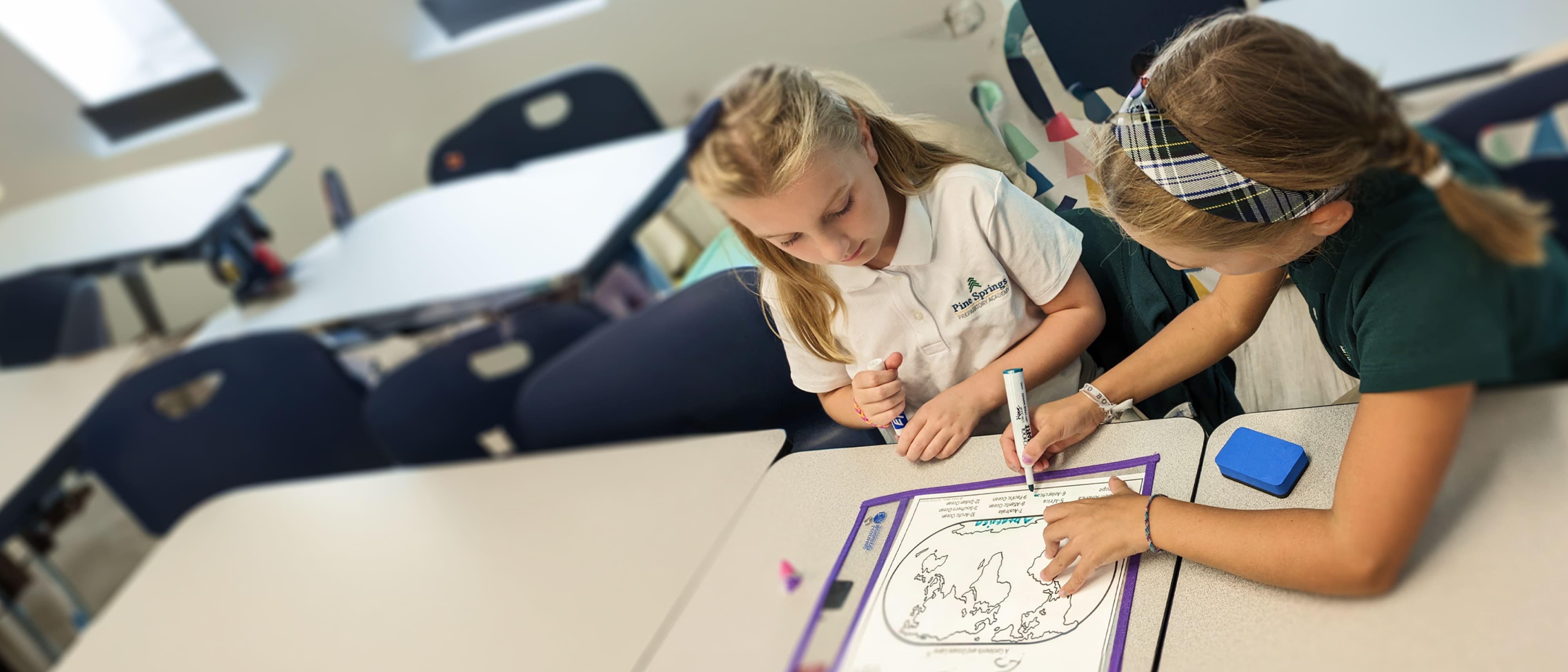 a girl drawing on a piece of paper