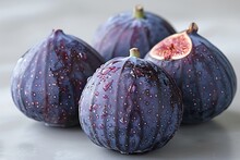 a group of figs on a white surface