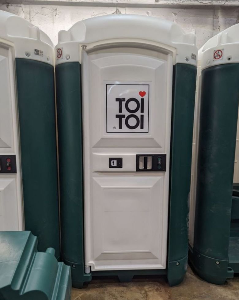 a white and green portable toilets