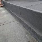 a concrete sidewalk with a curb