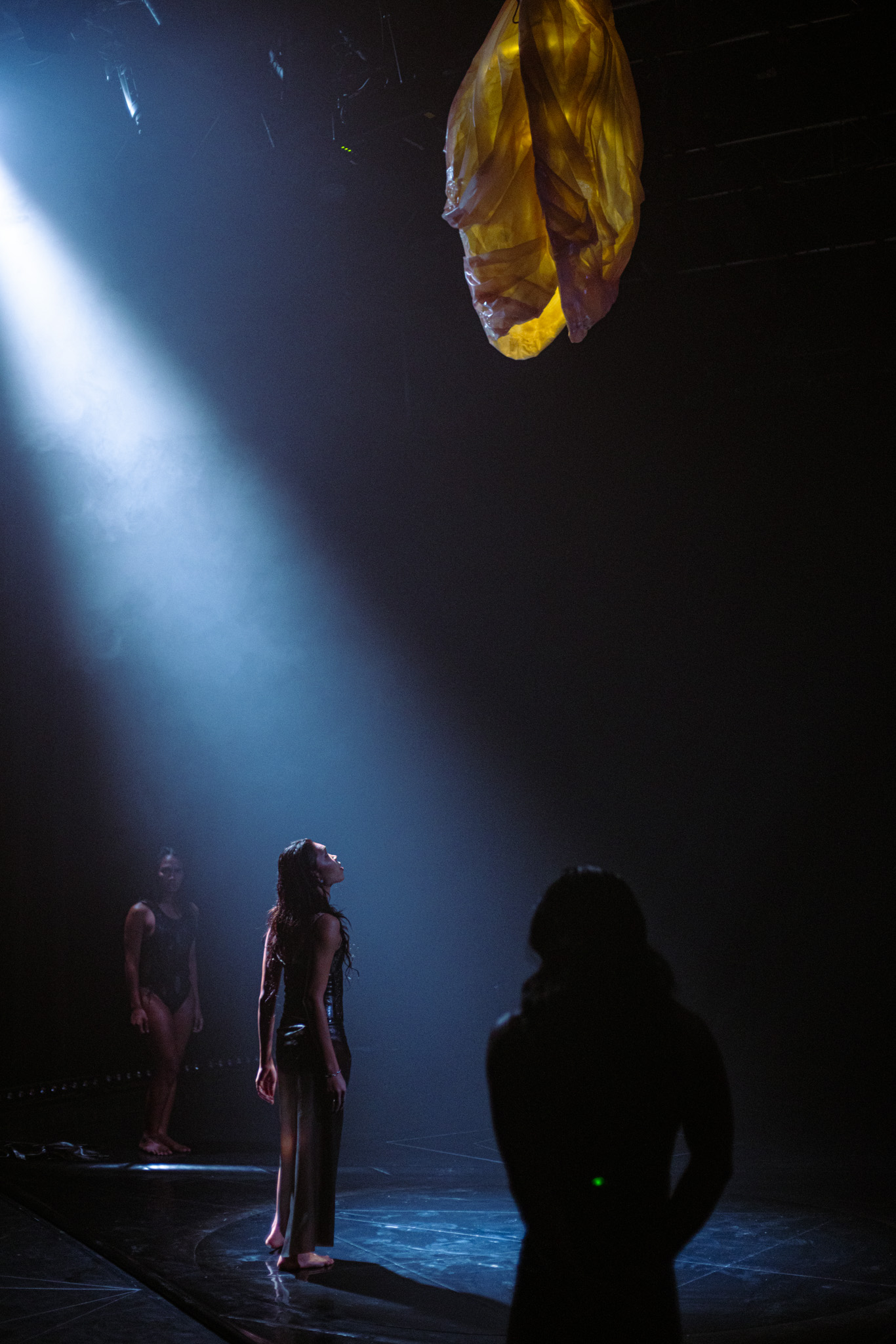 a group of people looking at a yellow object