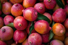 a pile of fruit with green leaves