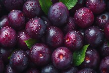 a pile of purple plums