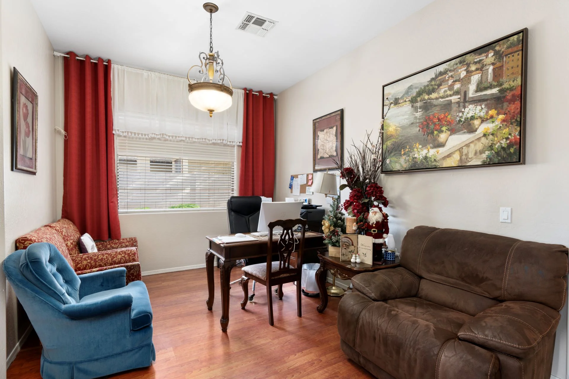 a living room with a desk and couches