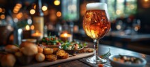 a glass of beer and food on a table