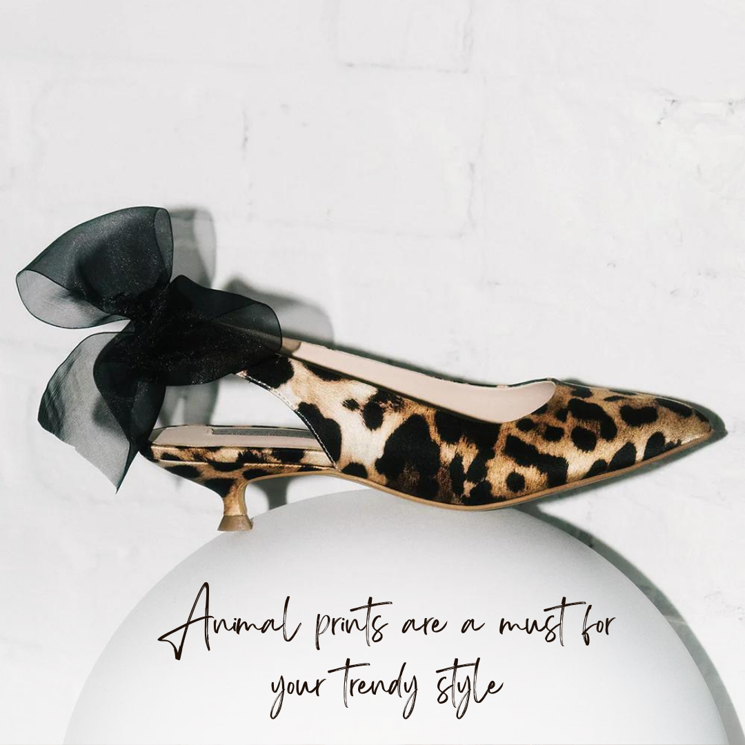 a leopard print high heeled shoe on a white ball