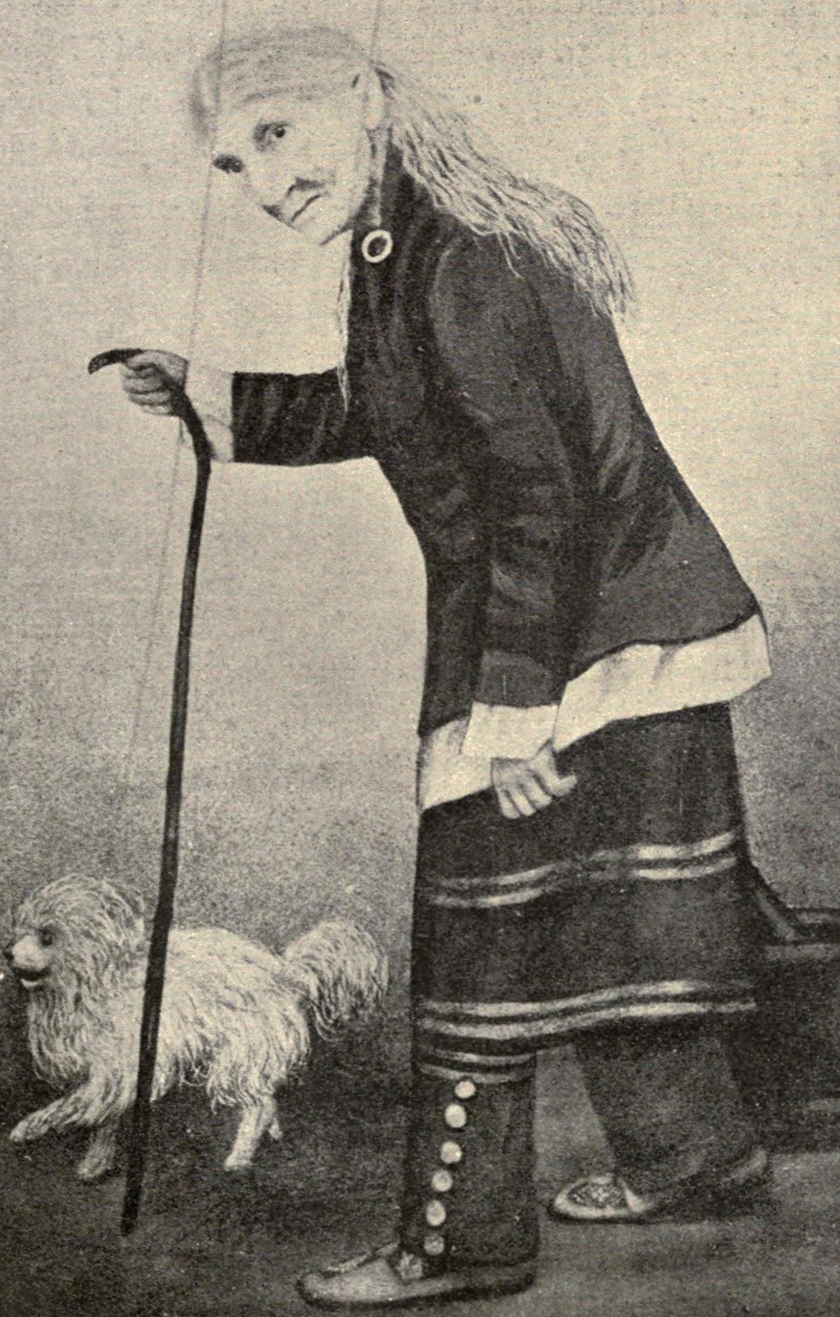 a woman with a cane and a dog