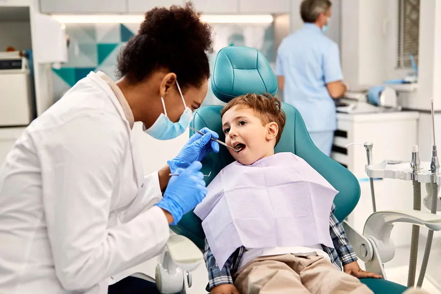 a child sitting in a dentist chair