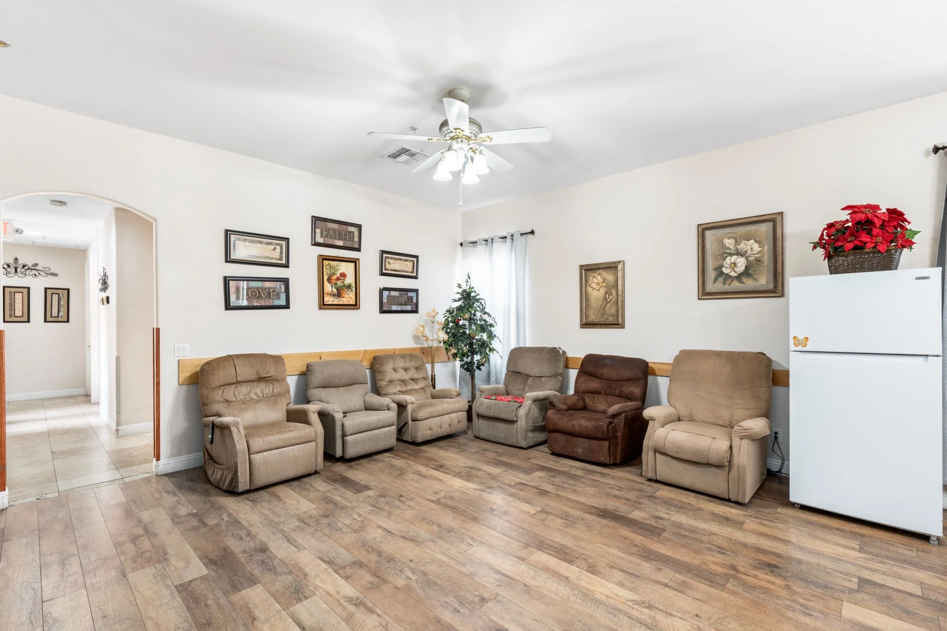 a room with many chairs and a fan