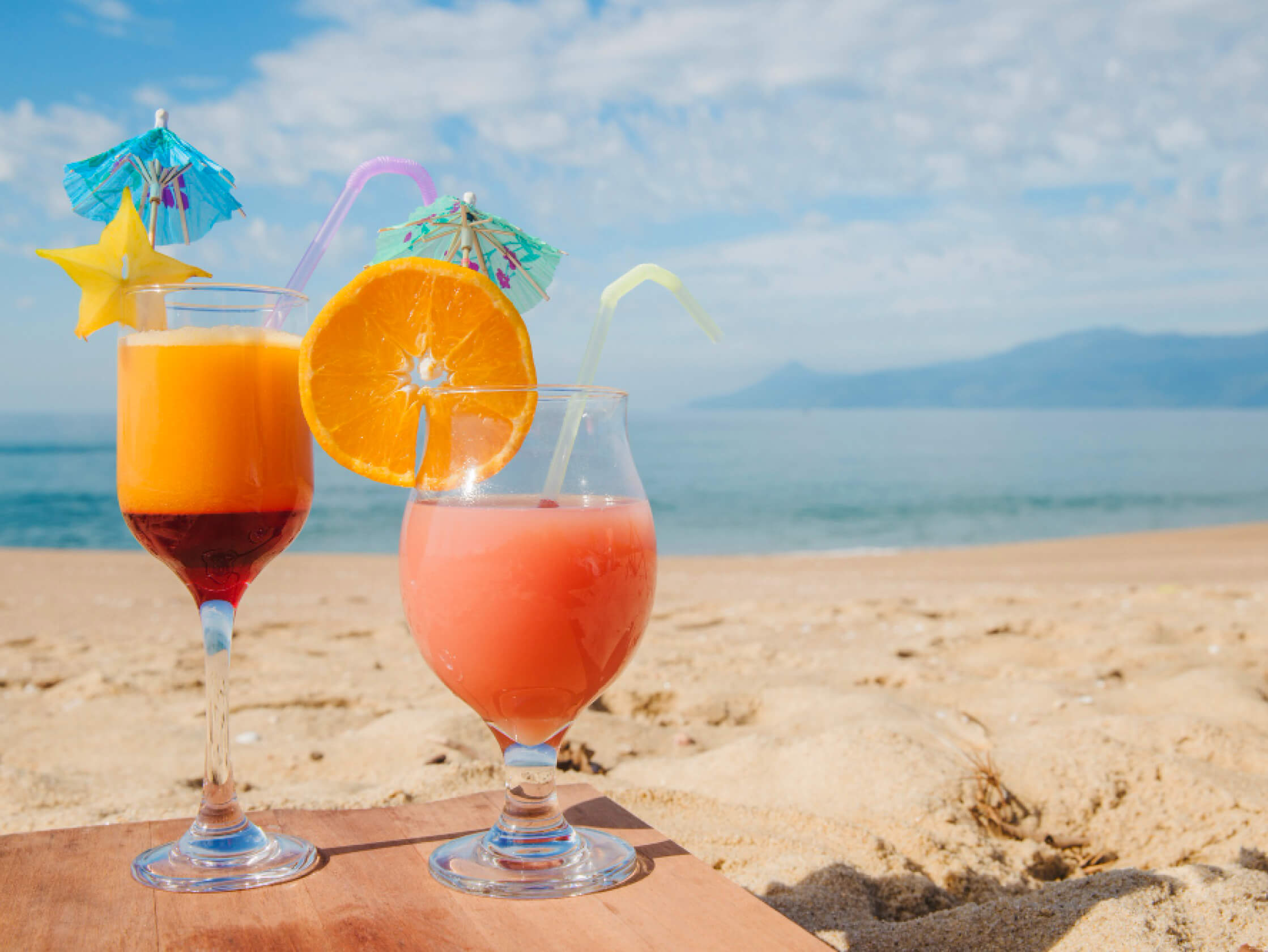 a group of drinks on a beach