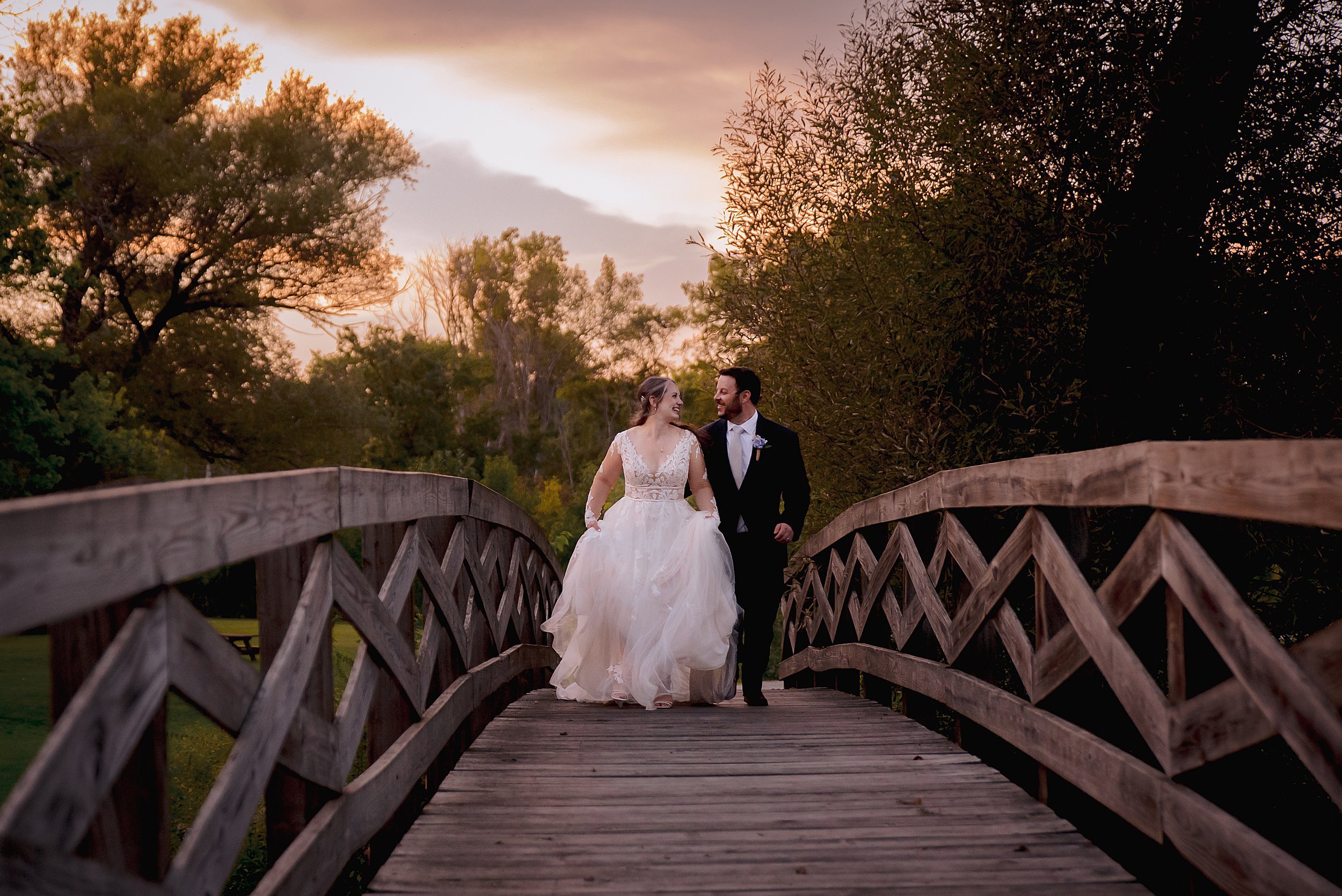 a man and woman walking on a bridge