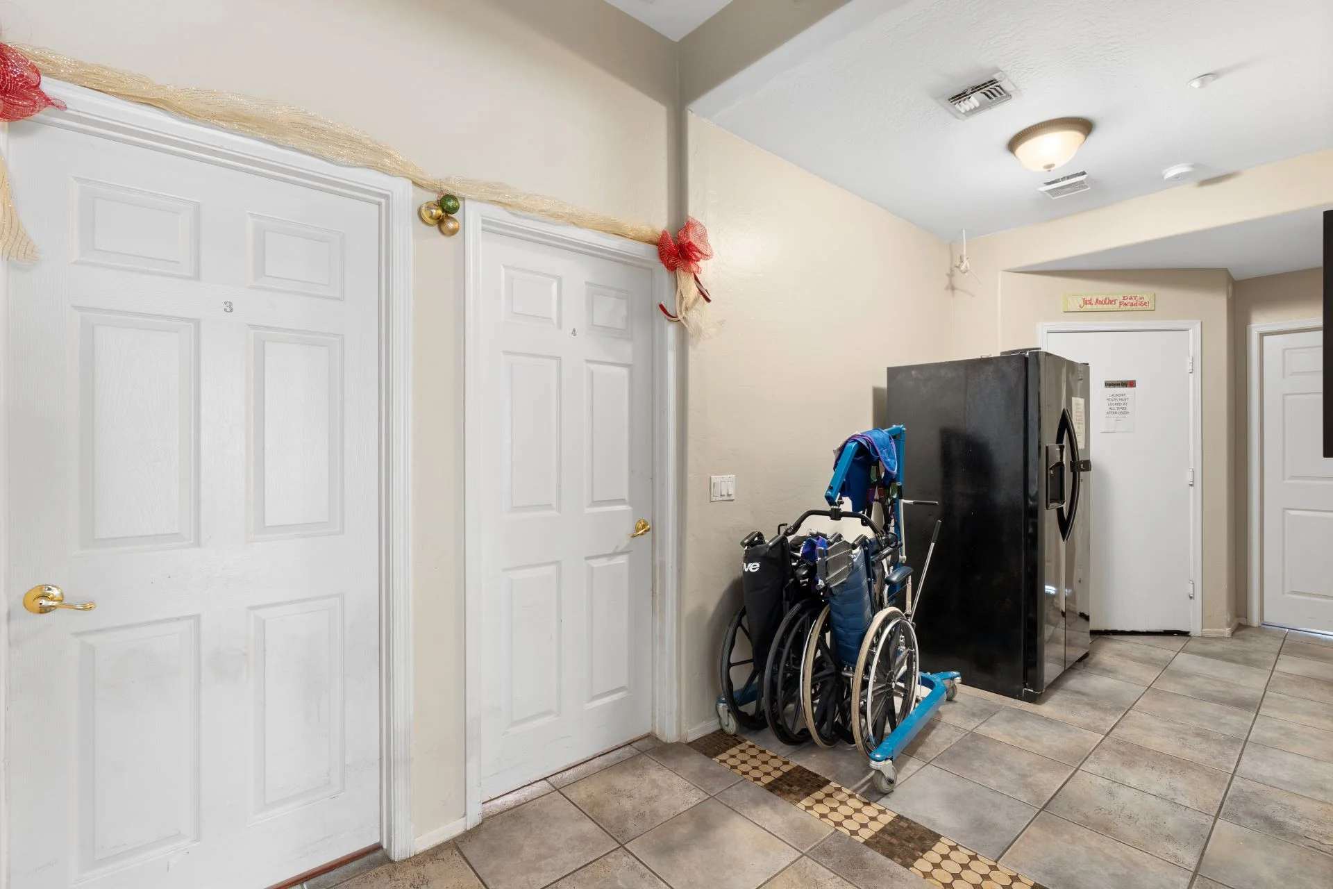 a wheelchair and a refrigerator in a hallway