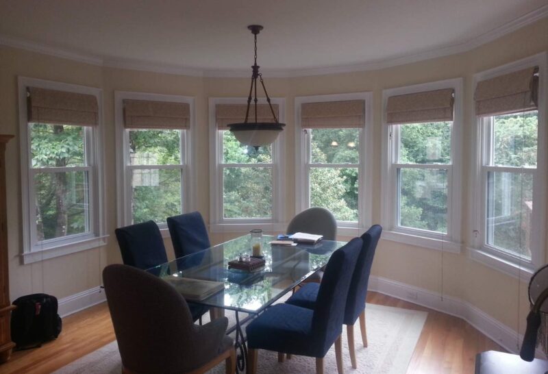 a dining room with a glass table and chairs