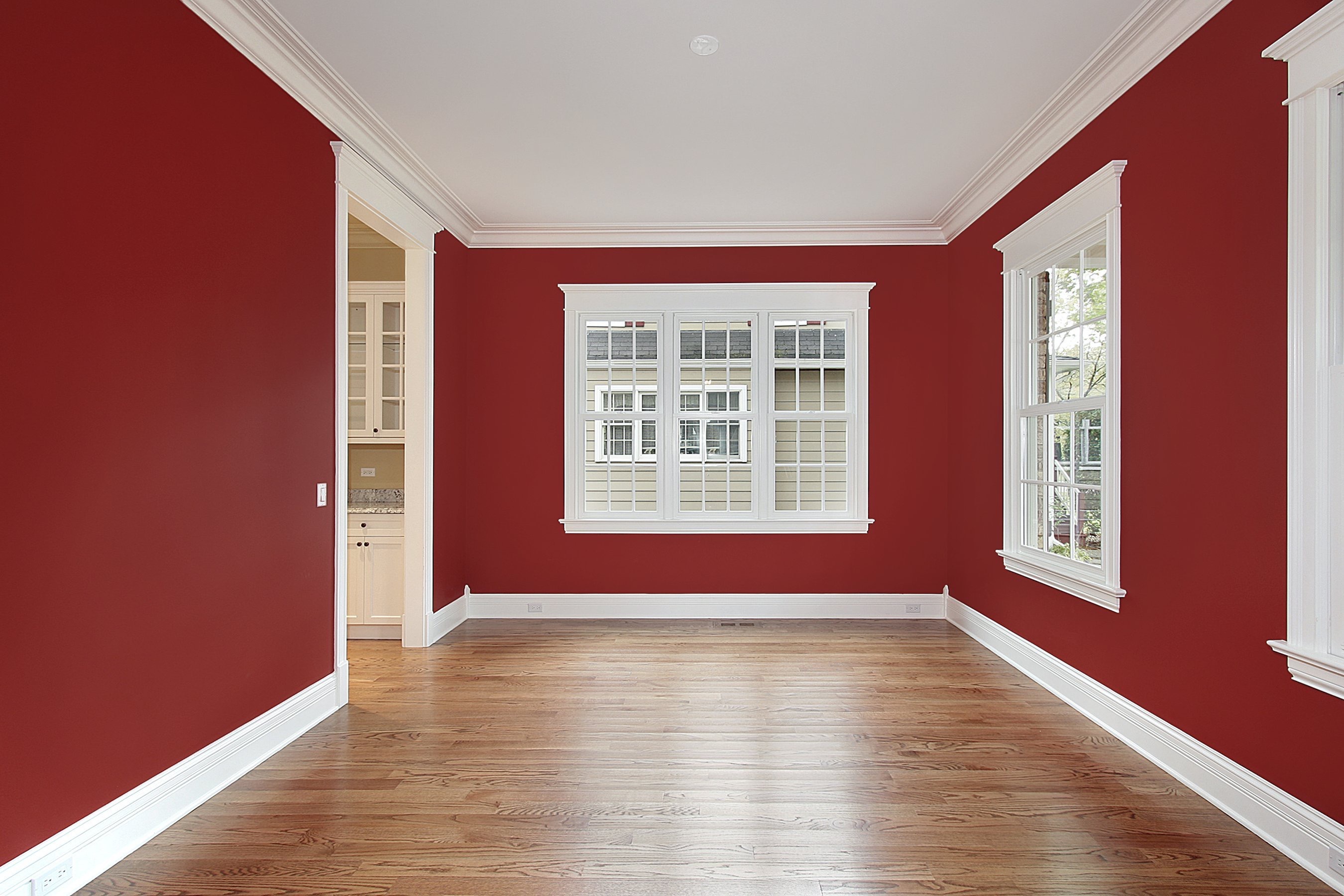 a room with red walls and white trim