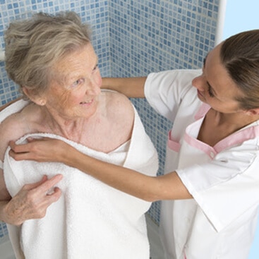 a woman in a white robe holding a woman in a white towel