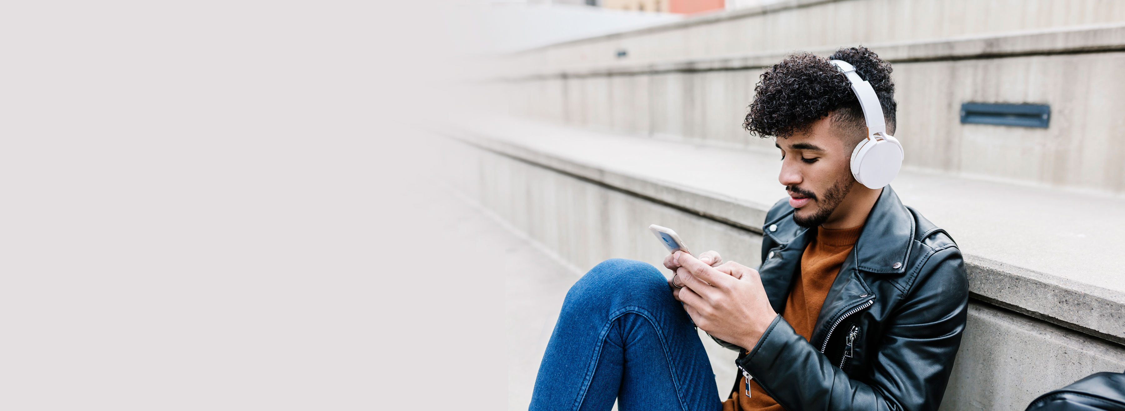 a woman sitting on a bench looking at her phone