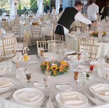 a restaurant setting with white tables and white chairs