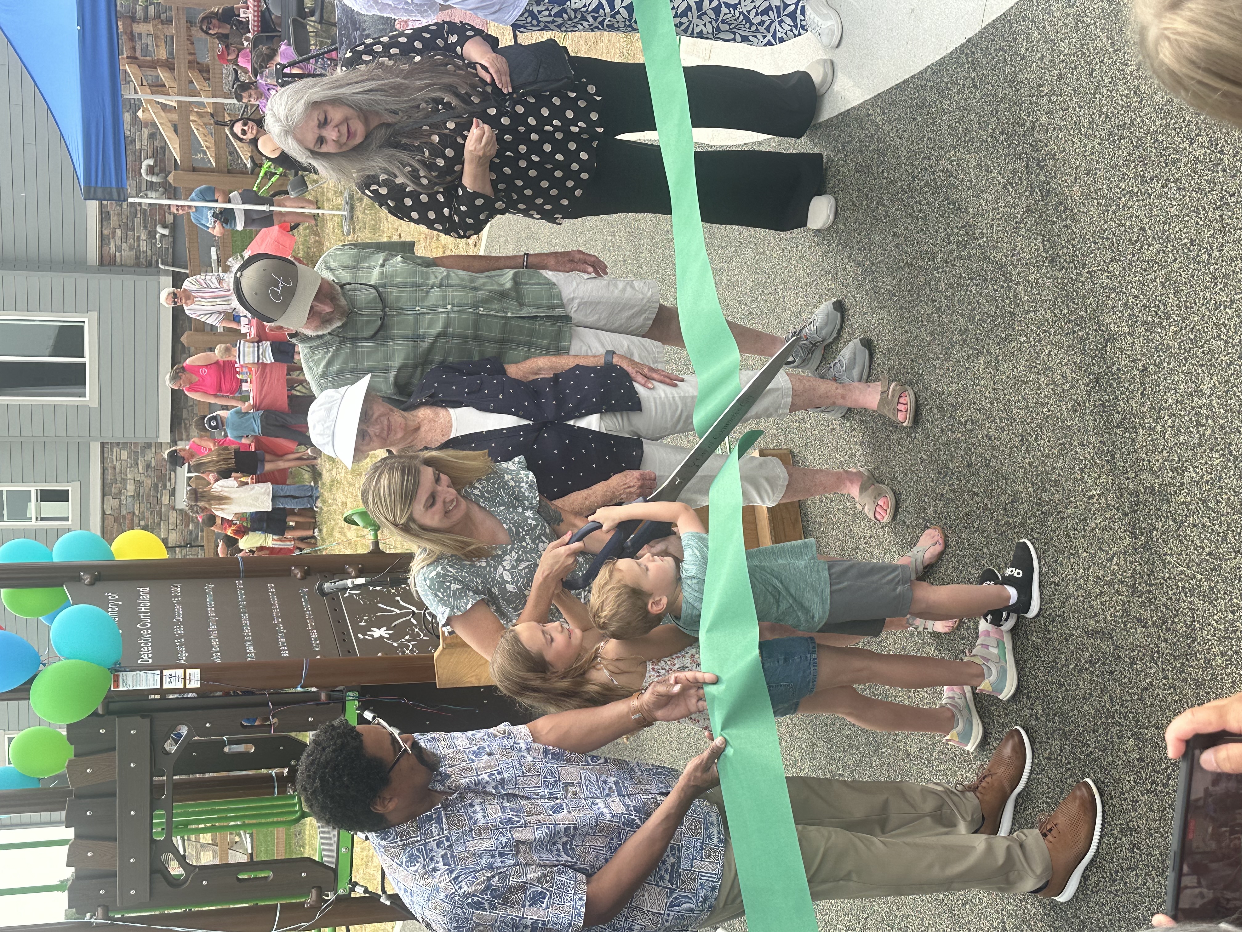 a group of people cutting a ribbon