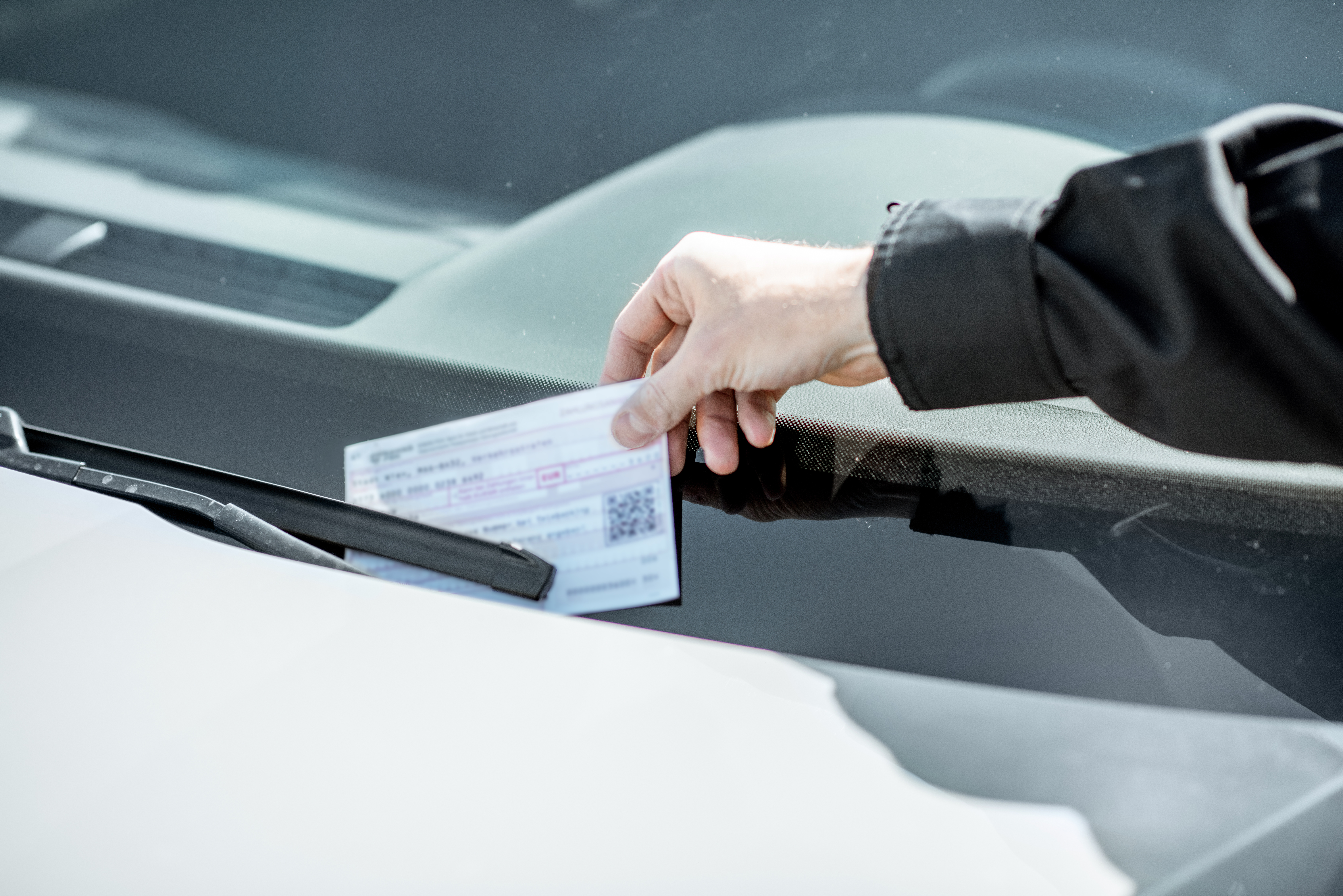 a person holding a ticket in a car