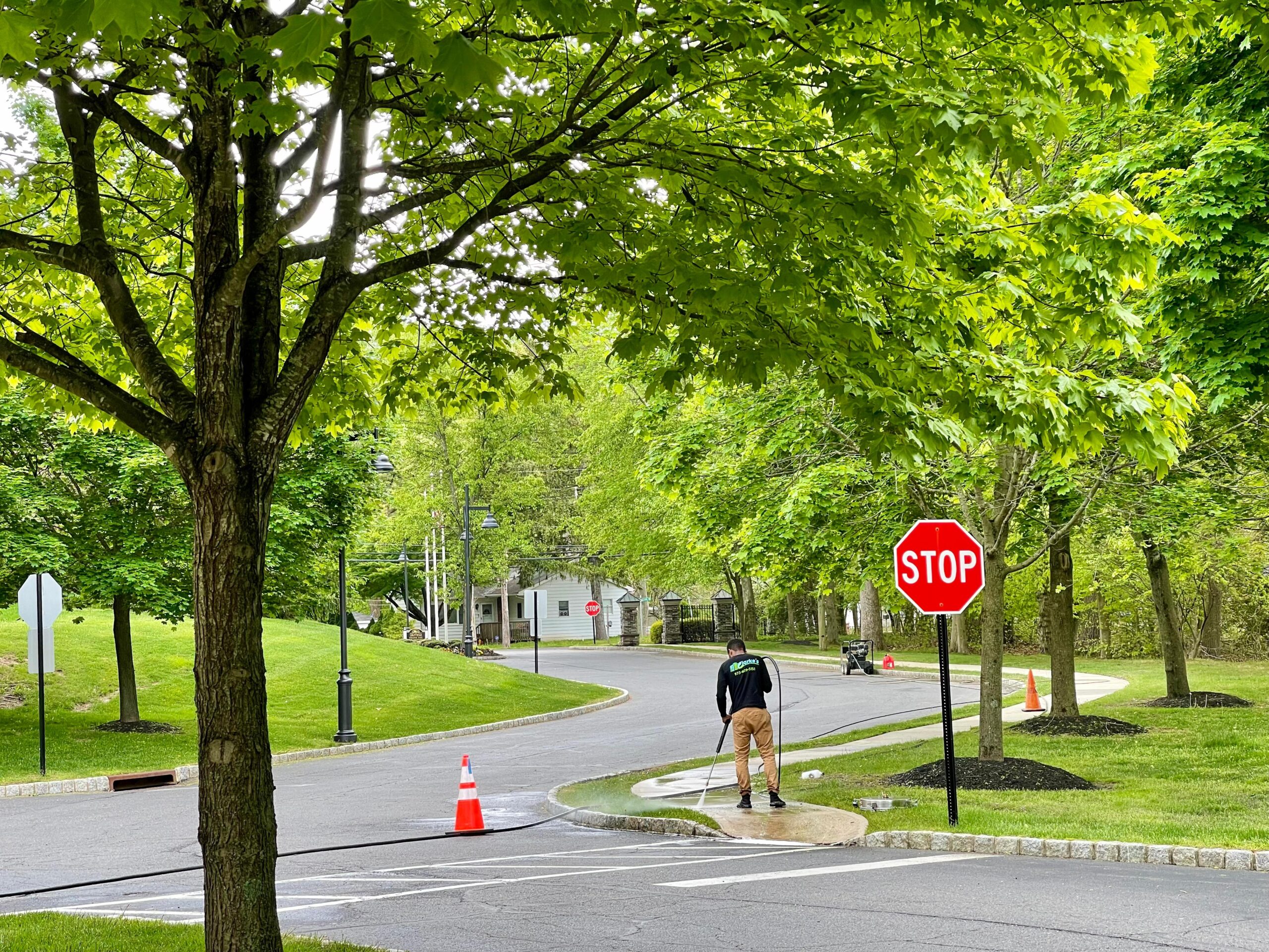 a man standing on a sidewalk with a stop sign