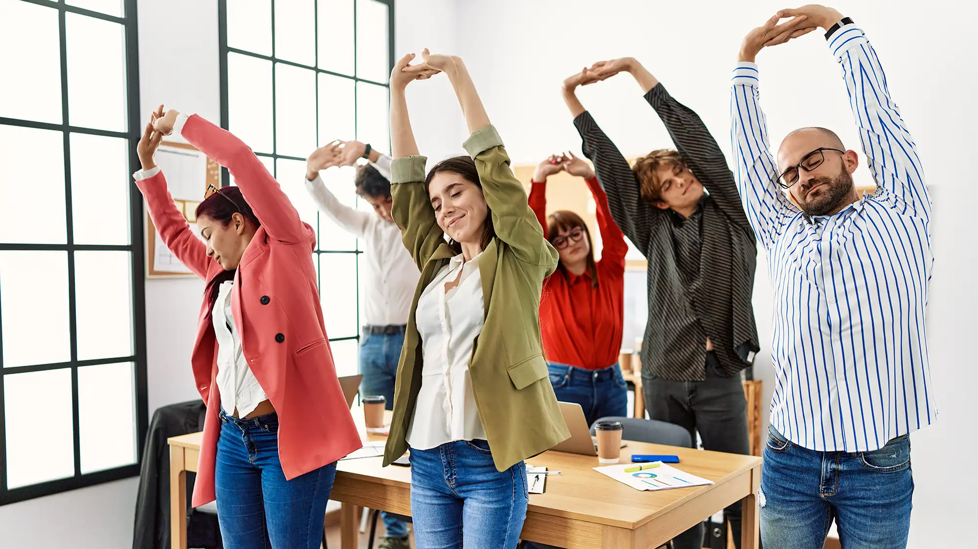 a group of people stretching in a room