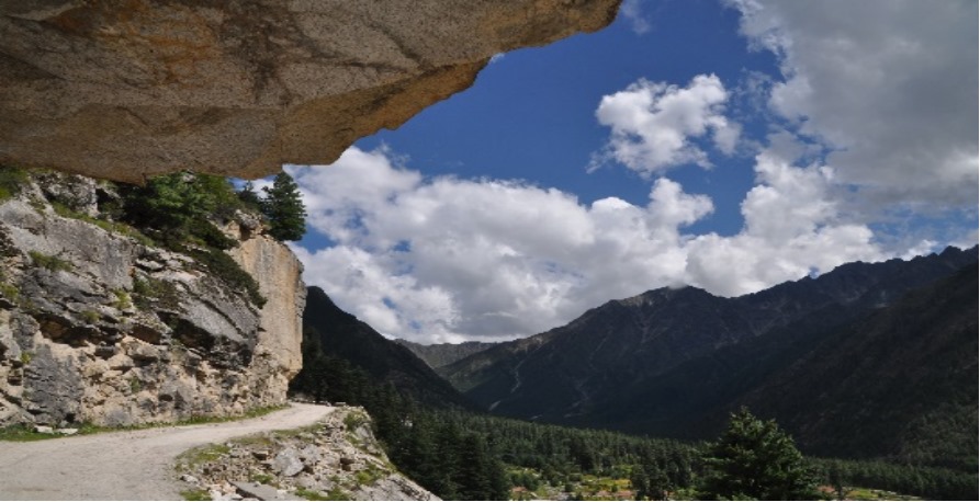 a view of a mountain range from a cliff