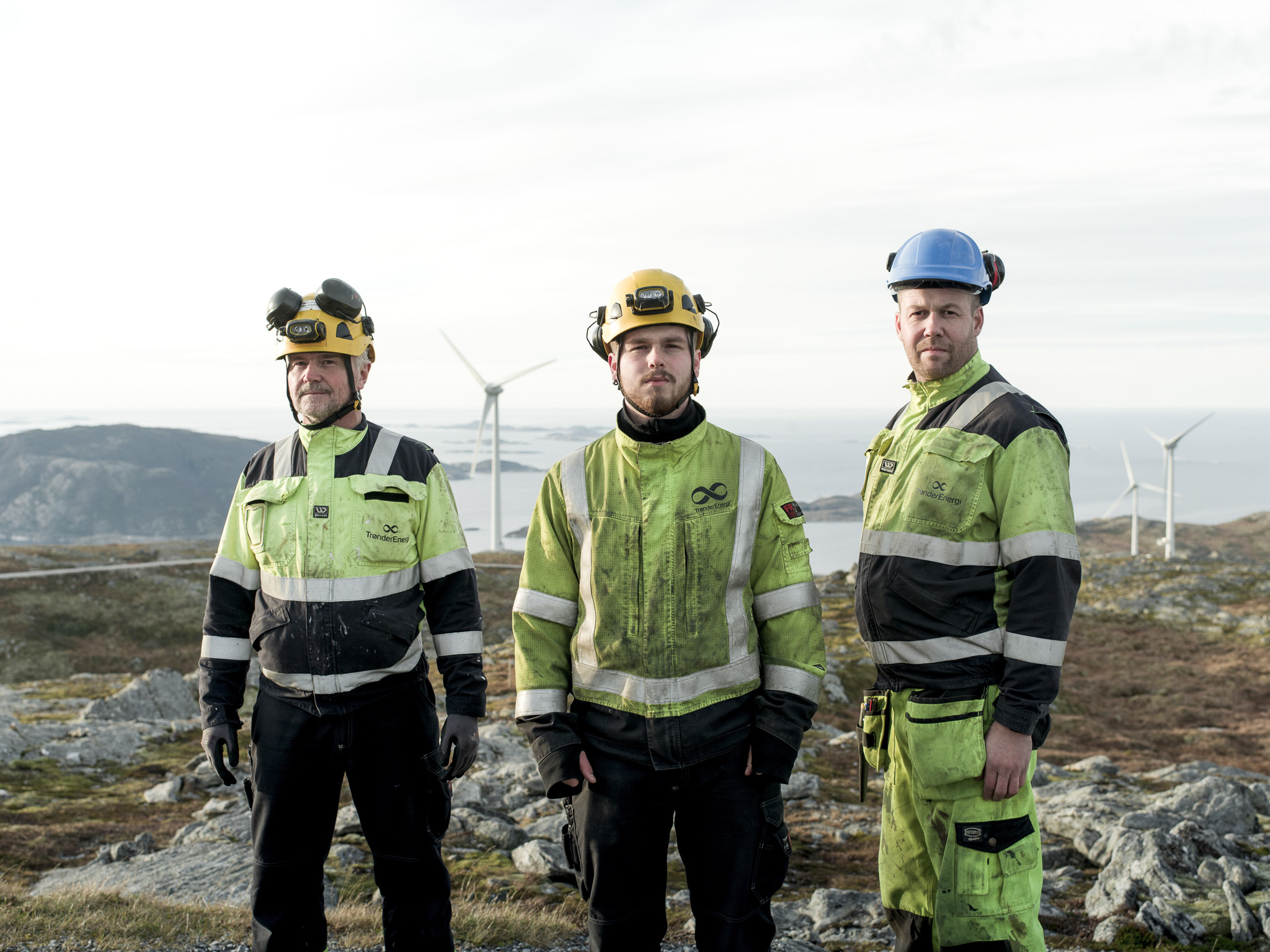 a group of men wearing hard hats and jackets