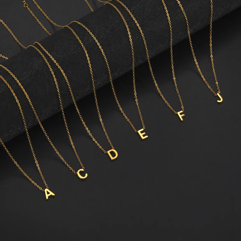a row of gold necklaces with letters on them