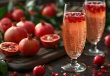 two glasses of champagne with pomegranates