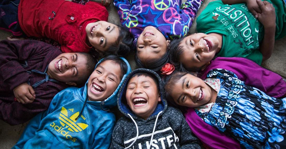 a group of children lying down smiling