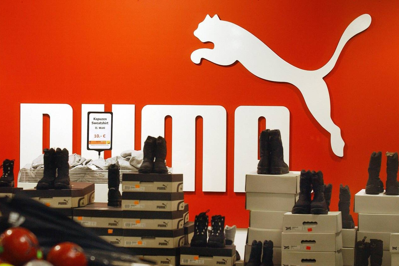 a shoe store with a logo on the wall