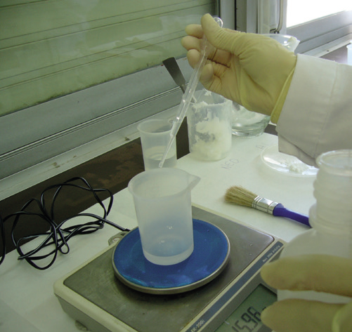 a person holding a beaker and measuring cup