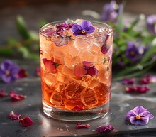 a glass with ice and flowers on it