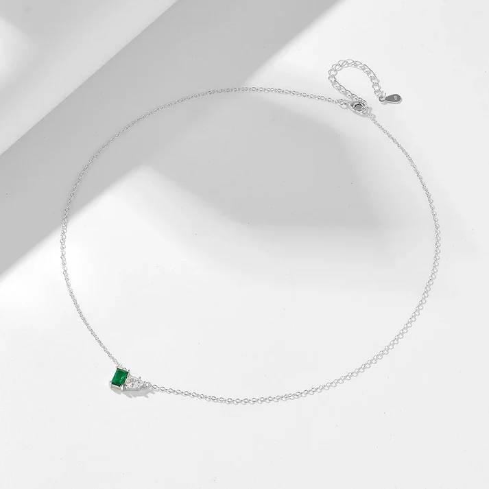 a necklace with a green stone