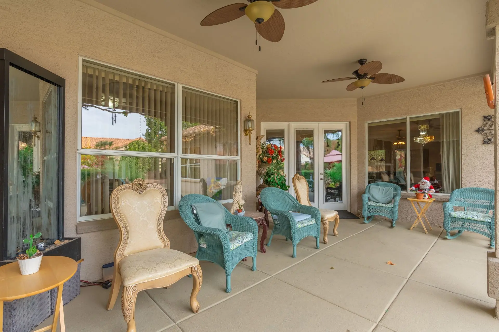 a patio with chairs and a fan