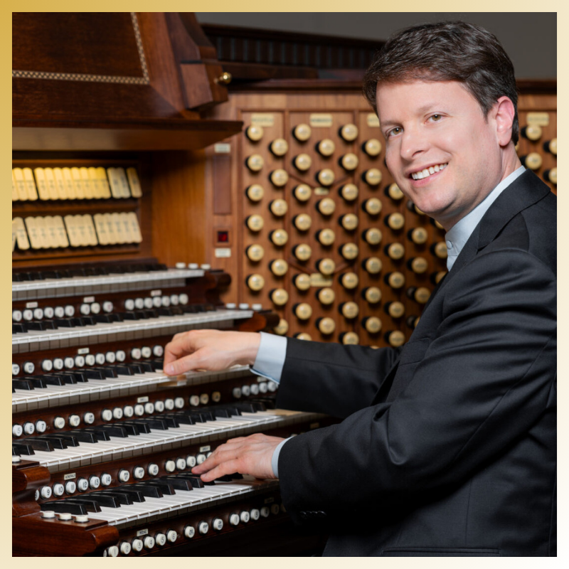 a man in a suit playing an organ