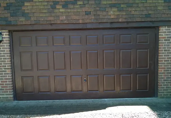 a garage door with a brick roof