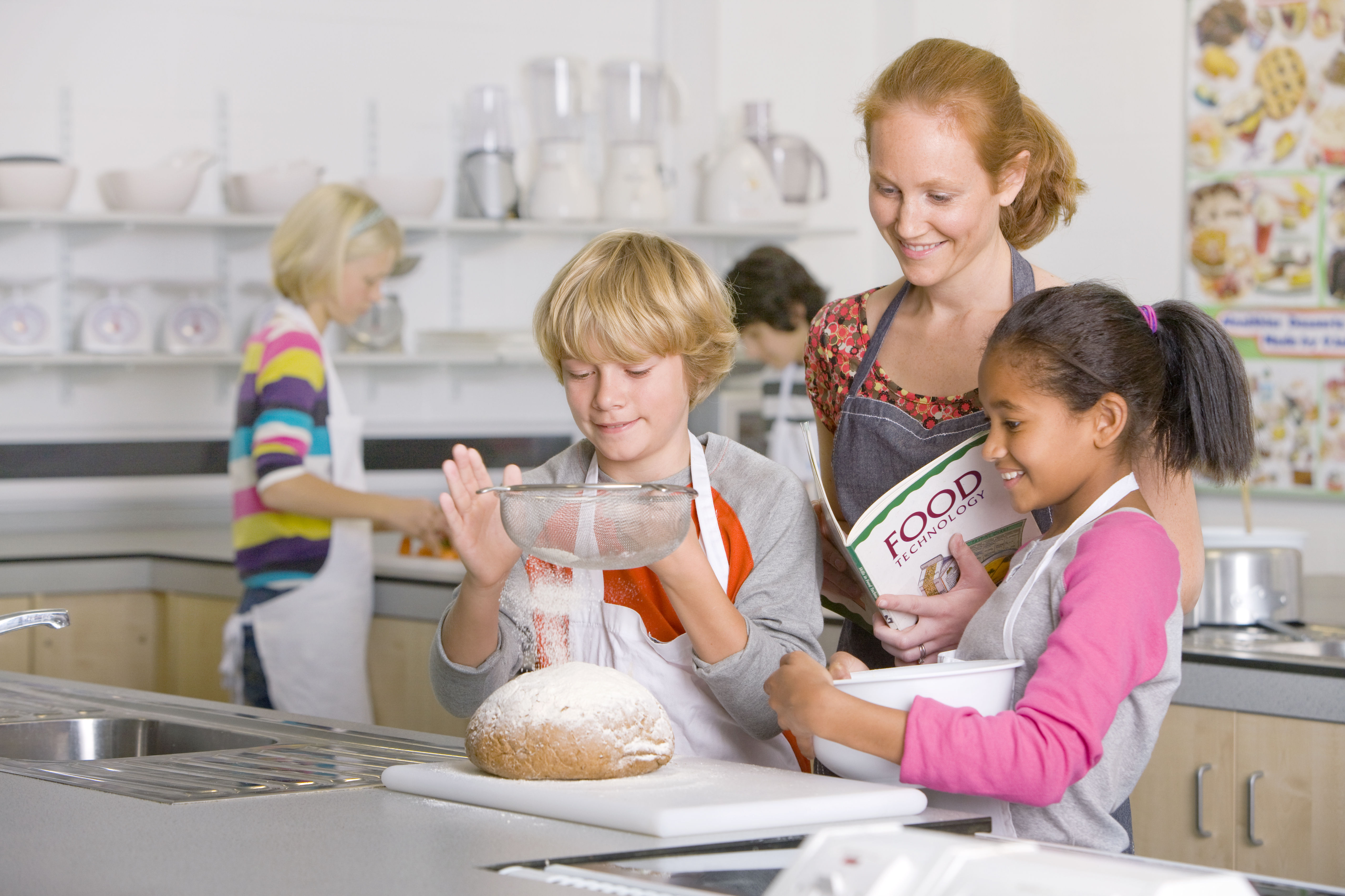 a woman and children in a kitchen