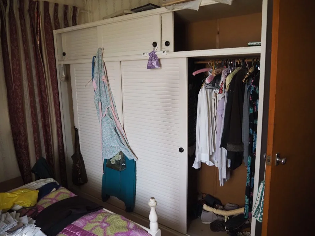 a closet with clothes in it