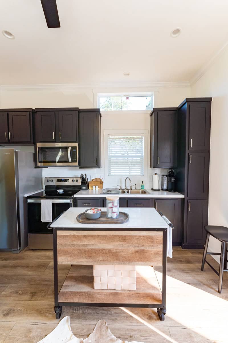 a kitchen with black cabinets and a table