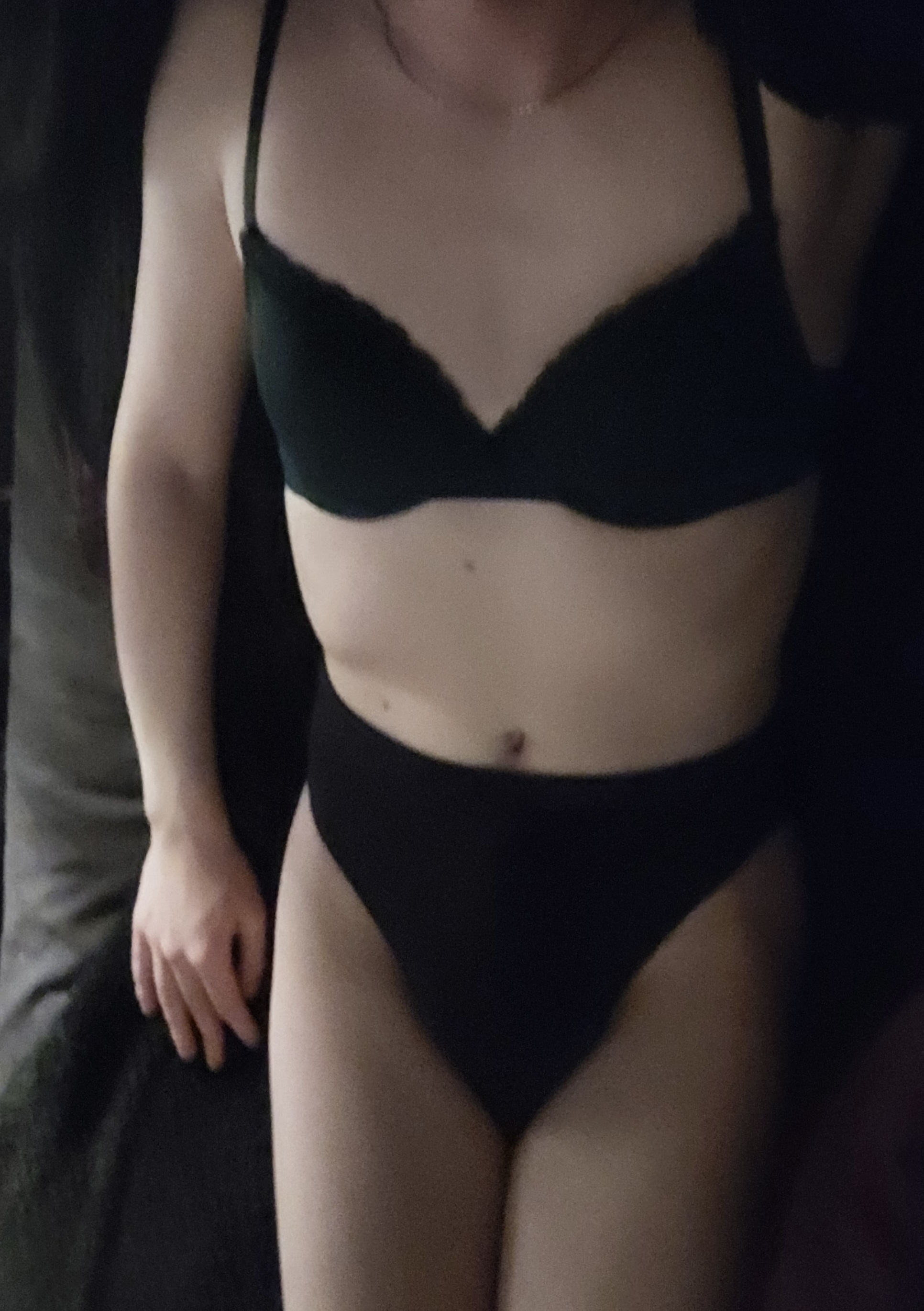 a woman wearing a black garment and underwear