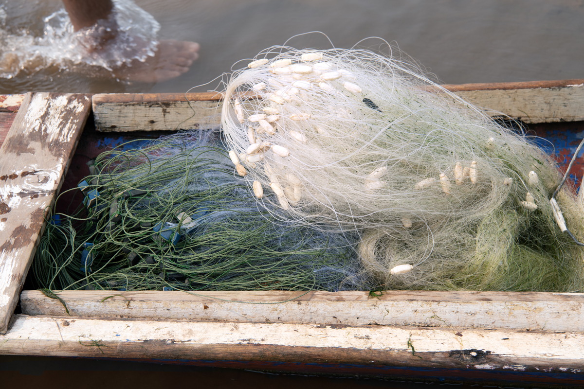a fishing net in a wooden boat