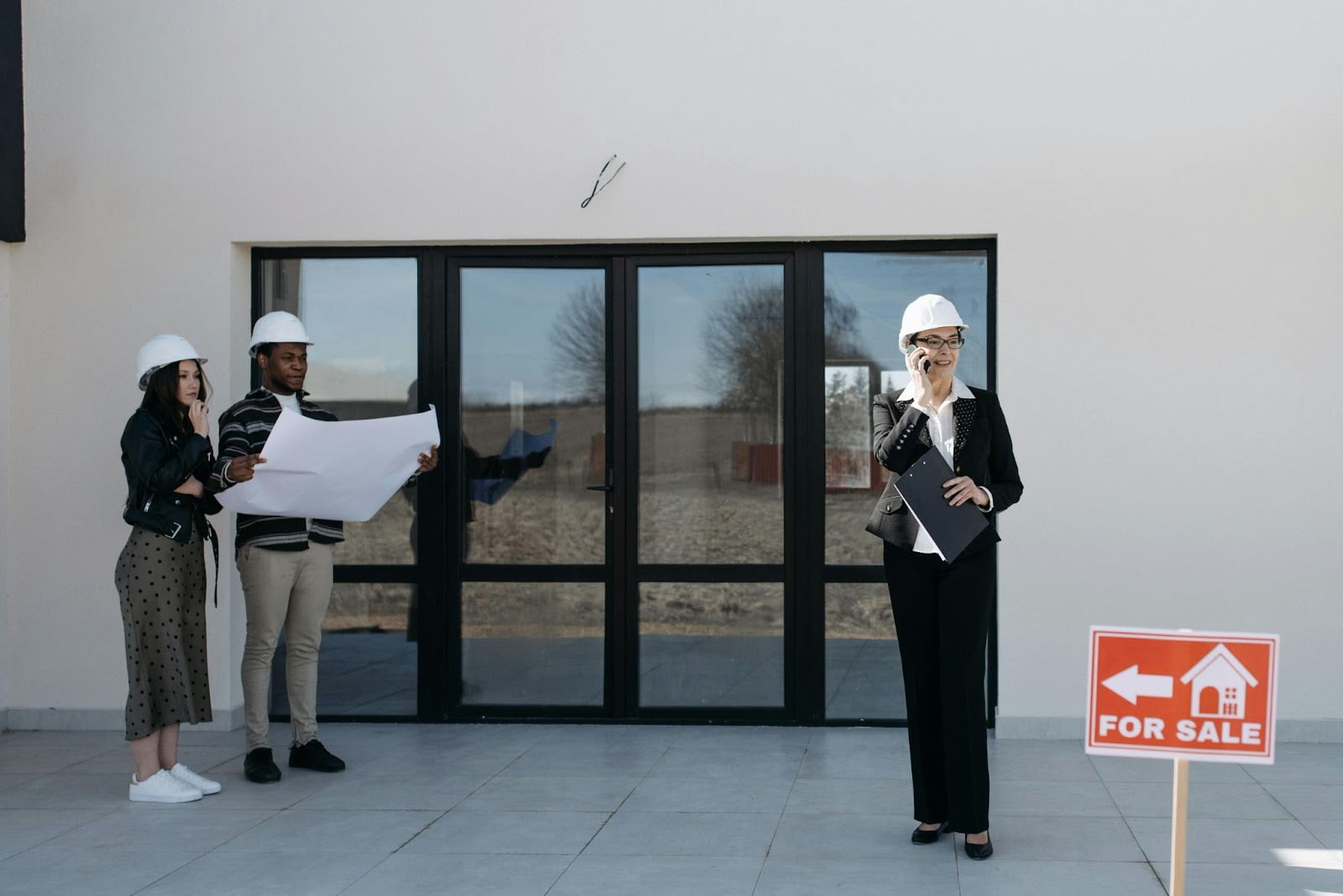 a woman in a hardhat talking on a phone